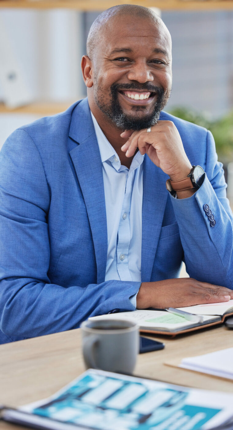 Happy black man, business manager and ceo working at modern office desk as financial investor, stock market trader and corporate worker in Nigeria. Portrait smile of african executive leader and boss.